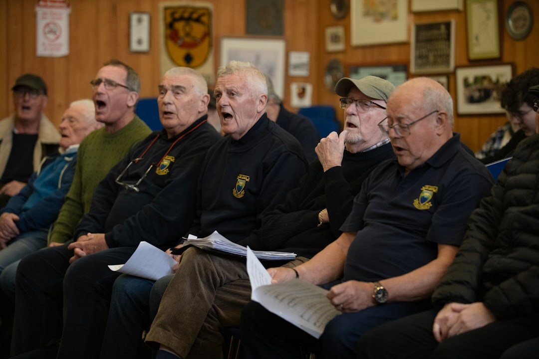 Choir of elderly people singing together in a community hall