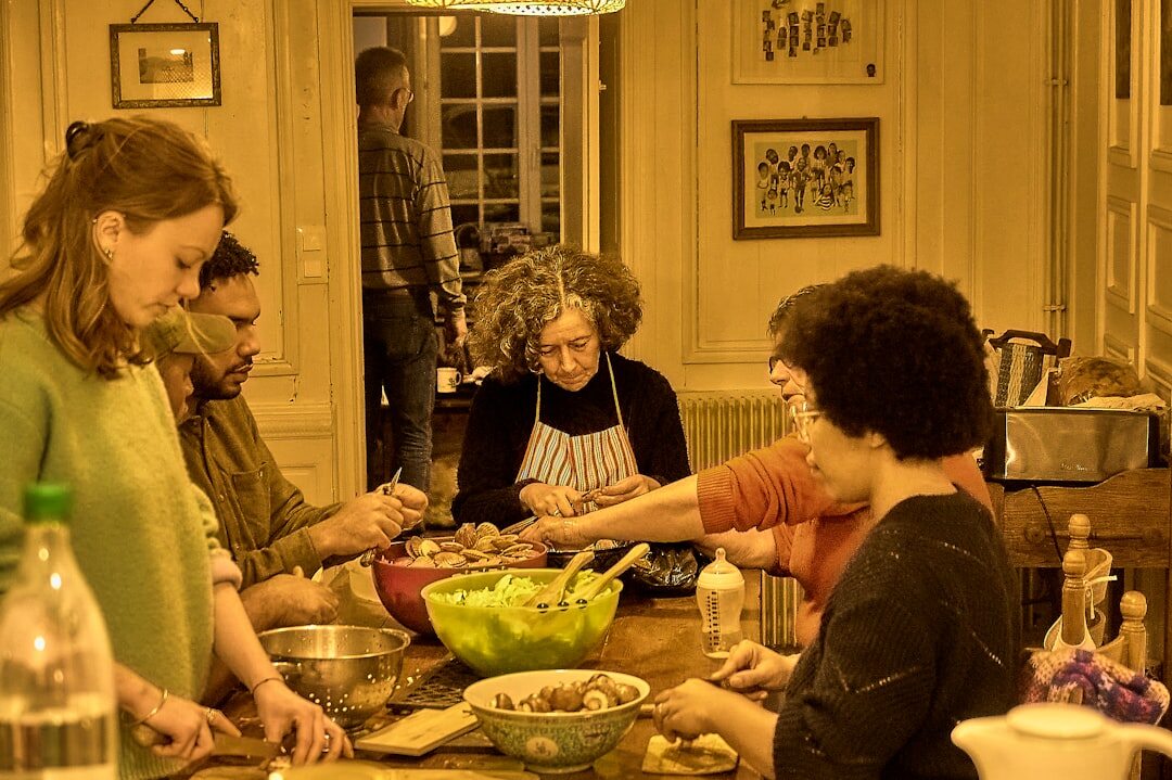 Group of seniors cooking together in a community kitchen